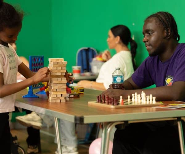 Youth worker and child playing game