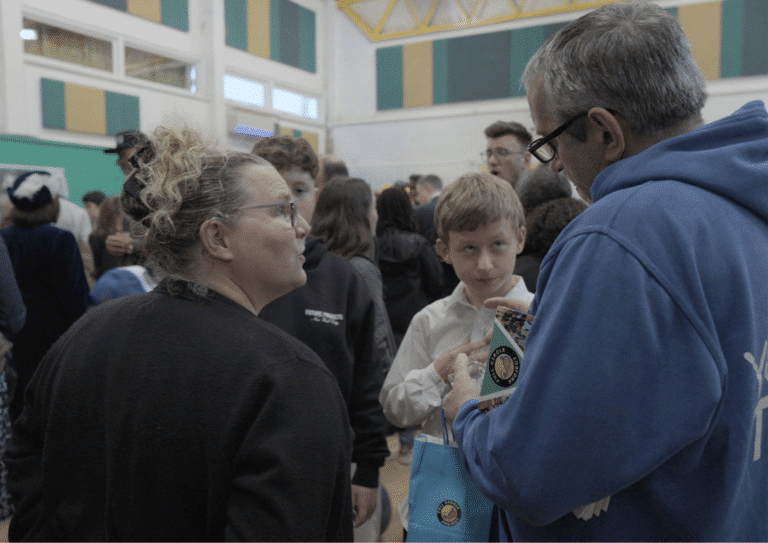 Adults talking to a young person at a Full Circle event.