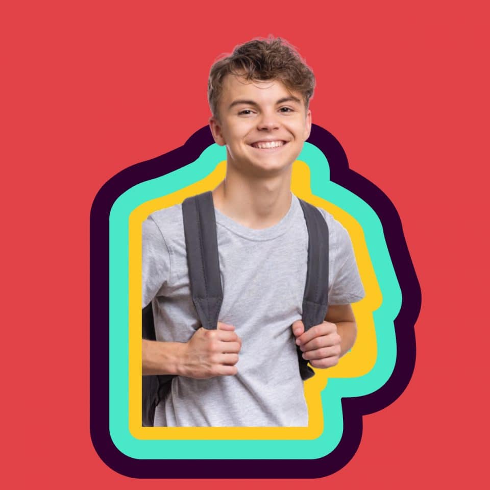 Young boy smiling with back pack on colurful background